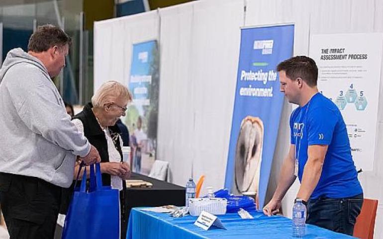 An NWMO employee explains the impact assessment process at an event